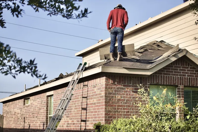 Professional roofer working on a residential roof in Bunker